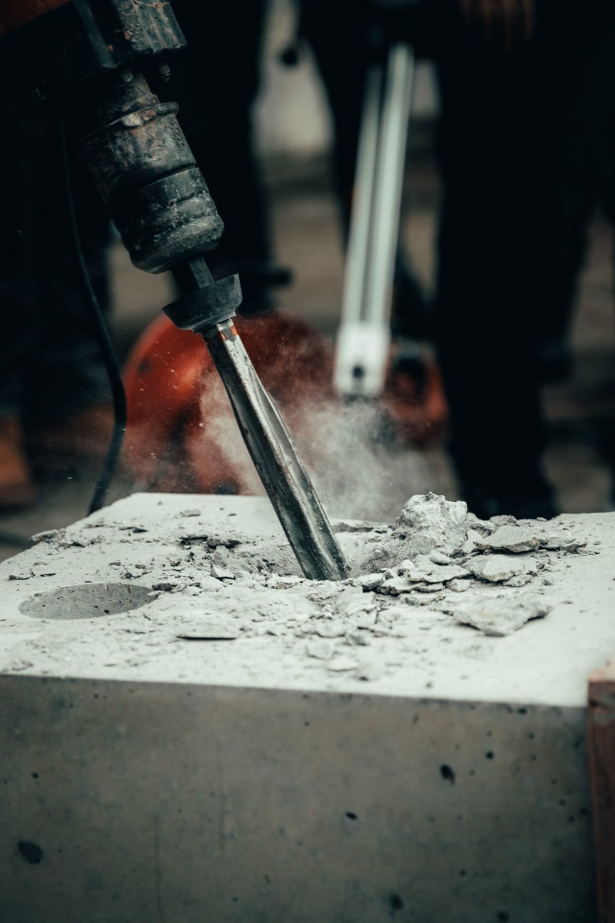 Concrete slab being broken apart with a demolition hammer